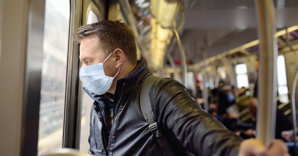 man wearing mask in luas train